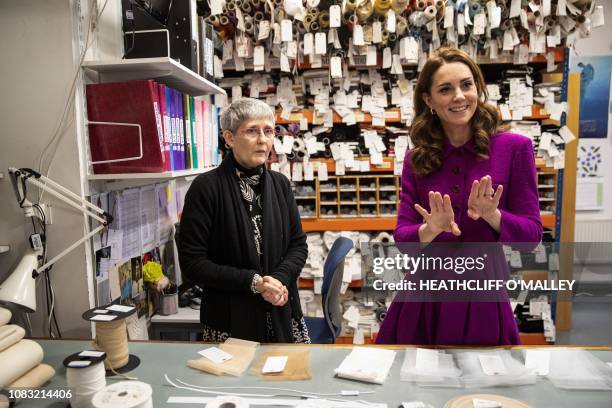 Britain's Catherine, Duchess of Cambridge, talks with stock room supervisor Morag Beaton during a visit to the costume department at the Royal Opera...