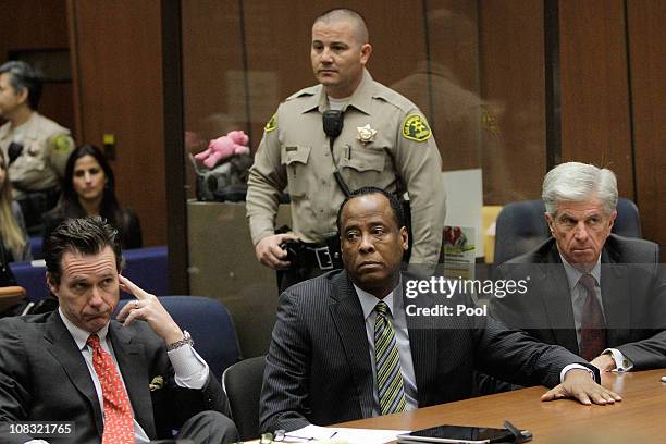 Dr. Conrad Murray appears in court with defense attorneys Edward M. Chernoff and John Michael Flanagan for an arraignment hearing on January 25, 2011...