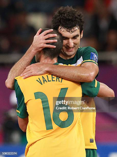 Carl Valeri of Australia celebrates scoring Australia's fifth goal with Mile Jedinak during the AFC Asian Cup Semi Final match between Uzbekistan and...