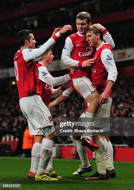 Nicklas Bendtner of Arsenal celebrates with team mates as he scores their first goal during the Carling Cup Semi Final Second Leg match between...