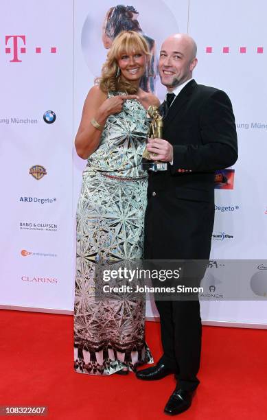 Award winner Bernd Heinrich Graf 'Unheilig' and Franziska van Almsick pose with award trophy during the Diva Award 2011 at Hotel Bayerischer Hof on...