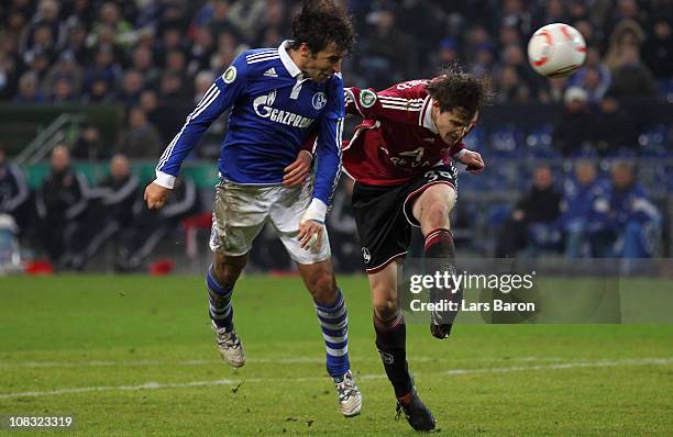 Raul Gonzalez of Schalke goes up for a header with Philipp Wollscheid of Nuernberg during the DFB Cup quarter final match between FC Schalke 04 and...