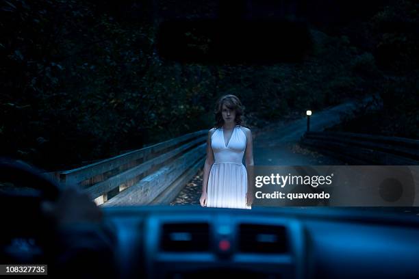 wunderschöne ghostly frau auf der straße, im auto scheinwerferlicht gefangen - hitchhike stock-fotos und bilder