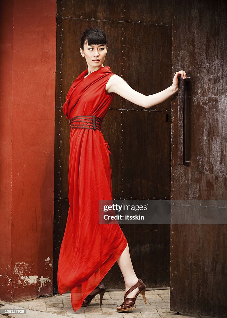 Young asian woman in red dress