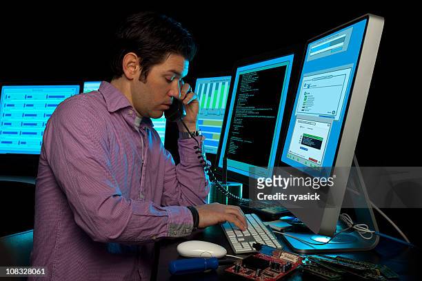 it data manager phone support surrounded by computer monitors - person surrounded by computer screens stock pictures, royalty-free photos & images