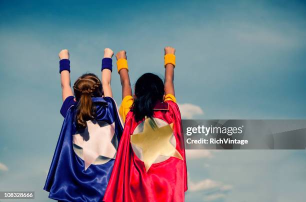 super girl duo - super strength stock pictures, royalty-free photos & images