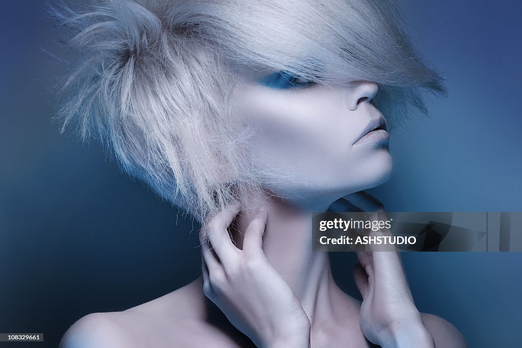 Fashion model posing on blue background