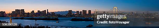 tokyo bay rainbow bridge odaiba downtown skyscrapers panorama sunset japan - replica statue of liberty odaiba stock pictures, royalty-free photos & images