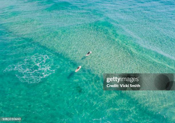 ocean waters with surfers seen from above - australia surfing stock pictures, royalty-free photos & images