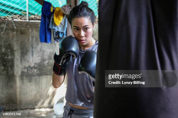 woman boxing in her garage - filipino boxers stock pictures, royalty-free photos & images