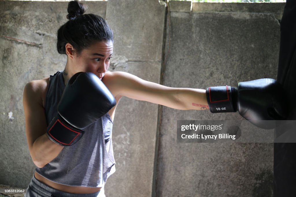 Woman boxing in her garage