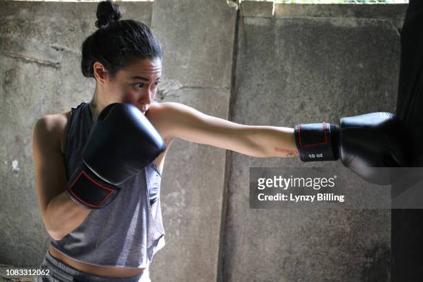 woman boxing in her garage