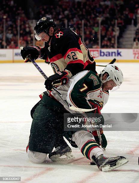 Tomas Kopecky of the Chicago Blackhawks and Matt Cullen of the Minnesota Wild battle for the puck after a face-off at the United Center on January...