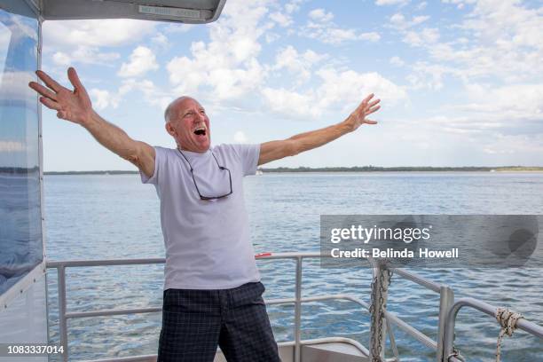 australian family enjoys the end of big day swimming in the ocean and dancing on their boat. - australia city lifestyle stock-fotos und bilder