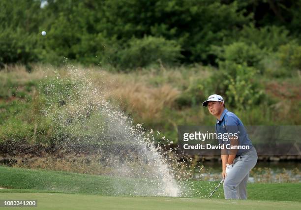 David Lipsky of the United States plays his second shot on the par 3, 16th hole from a plugged lie in the bunker during the final round of the Alfred...