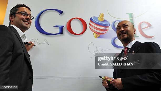 Julian Persaud, Managing Director of Google Southeast Asia, along with Malaysia's deputy trade and industry minister Mukhriz Mahathir sign a Google...