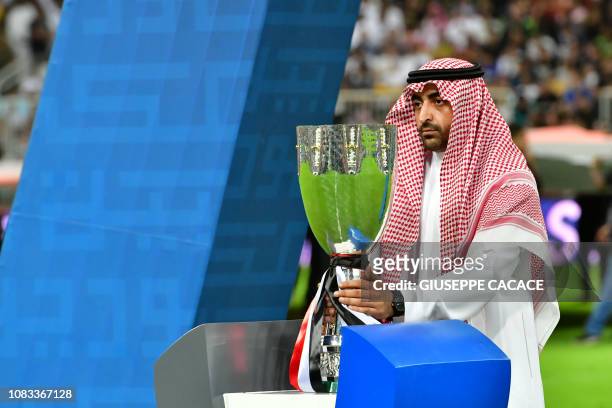 The Supercoppa Italiana trophy is brought onto the pitch ahead of the final between Juventus and AC Milan at the King Abdullah Sports City Stadium in...