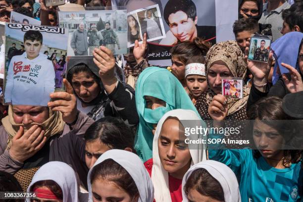 Yazidi women seen holding pictures of their beloved ones during the anniversary of the yazidi genocide. On August 3 the Islamic State destroyed the...