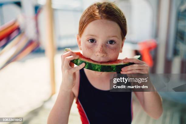 redhead kid with freckles eating watermelon on beach holiday,portrait - hot dirty girl stock pictures, royalty-free photos & images