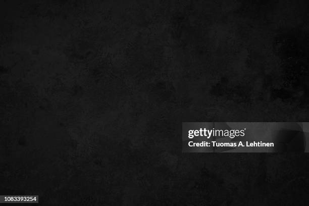 close-up of a weathered and aged dark gray, almost black, concrete wall, texture background. - color negro fotografías e imágenes de stock