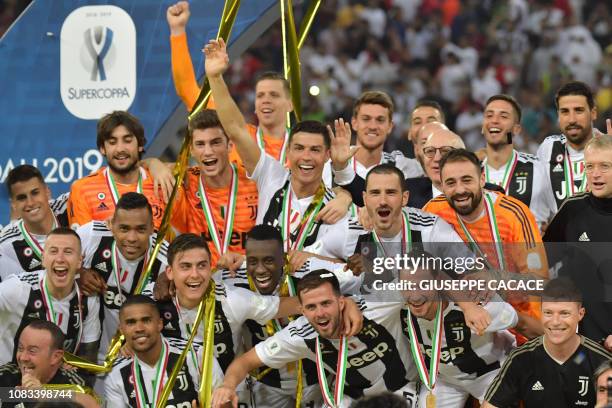 Juventus' Portuguese forward Cristiano Ronaldo and teammates celebrate their Supercoppa Italiana final win against AC Milan at the King Abdullah...