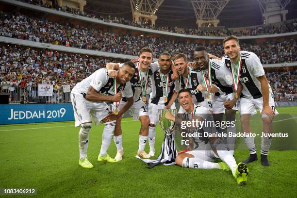 Alex Sandro, Paulo Dybala, Douglas Costa, Miralem Pjanic, Blaise Matuidi, Rodrigo Bentancur and Cristiano Ronaldo of Juventus celebrate with trophy...