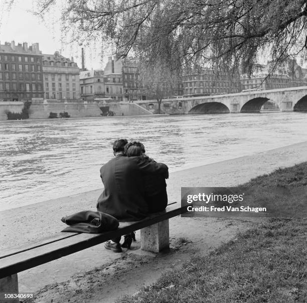 Courting couple on the bank of the Seine, Paris, 1954.