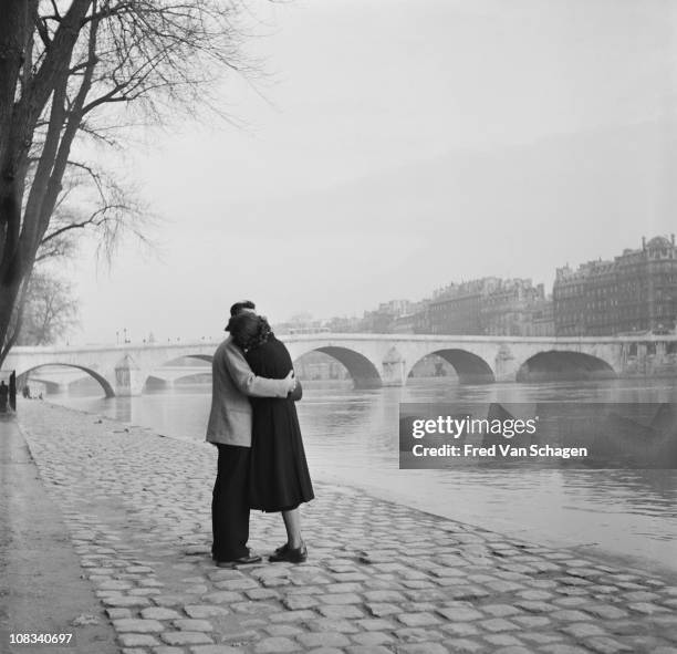 A courting couple on the bank of the Seine, Paris, 1954.