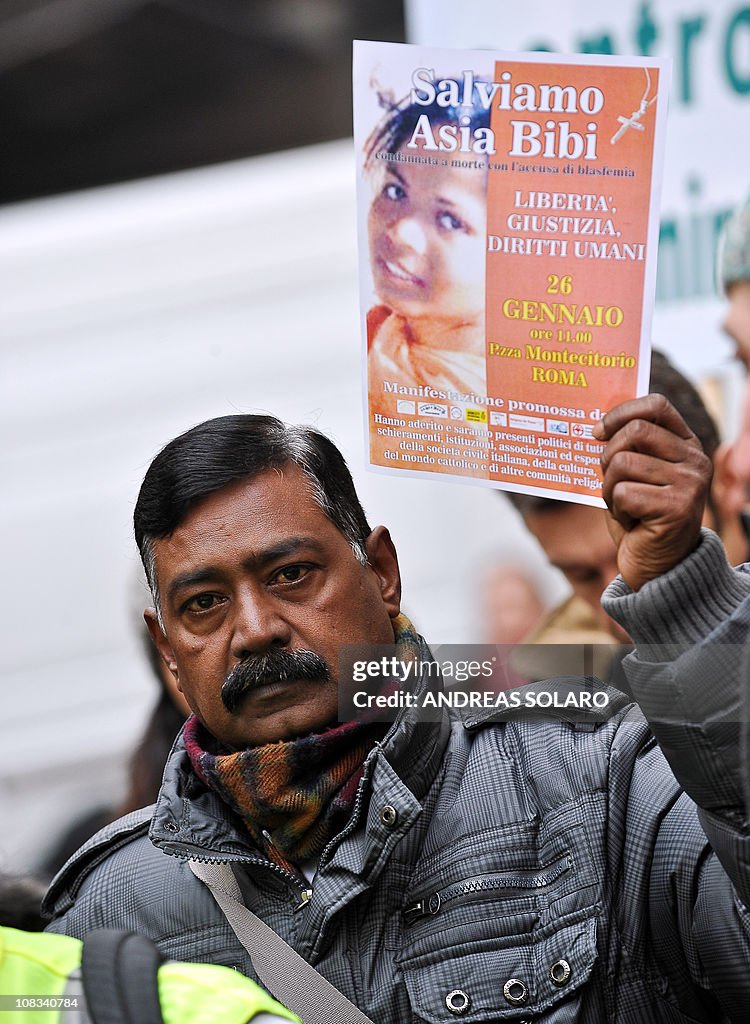 A man holds a placard reading "Save Asia