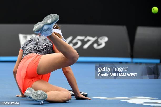 Belgium's Elise Mertens slips on the court as she plays against Russia's Margarita Gasparyan during their women's singles match on day four of the...