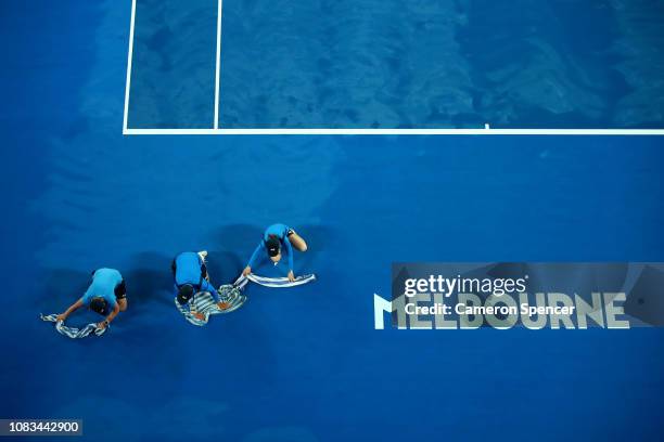 Ball kids work to dry the court on Rod Laver Arena during day four of the 2019 Australian Open at Melbourne Park on January 17, 2019 in Melbourne,...