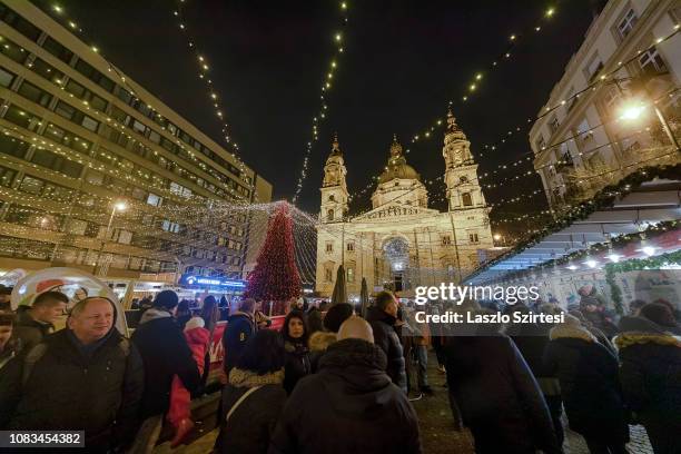 The crowd surges around the Christmas tree at the Szent István Bazilika on December 16, 2018 in Budapest, Hungary. The best-known Christmas Market of...