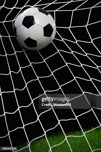 football striking on net, close up - night at the net stockfoto's en -beelden