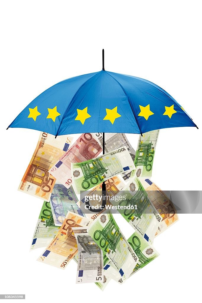 Euro banknotes under umbrella against white background