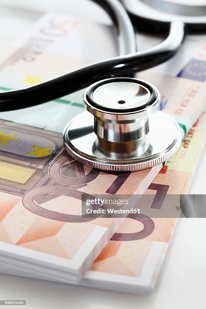 Stethoscope with Euro bank notes, close up