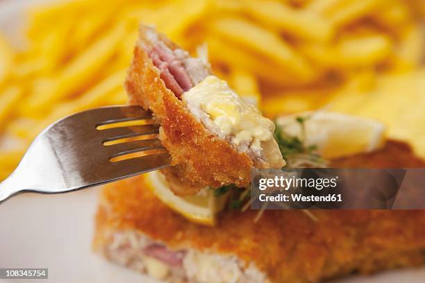 cordon bleu with potato fries and sauce hollandaise, close up - cordon bleu stock pictures, royalty-free photos & images