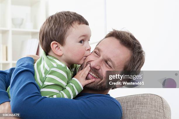 germany, bavaria, munich, son (2-3 years) kissing his father, smiling - 30 34 years bildbanksfoton och bilder