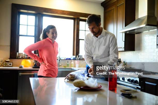 Robert Francis "Beto" O'Rourke, right, packs his homemade cookies in a bag as his wife, Amy Hoover Sanders, left, looks on in the kitchen of their...