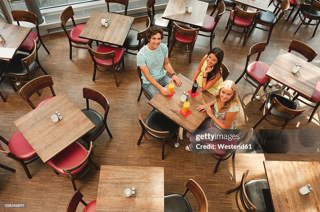 Germany, Munich, Friends together in cafe