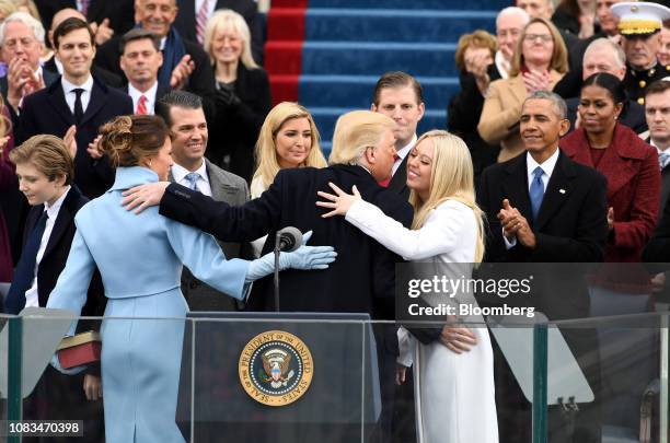 President Donald Trump embraces his family during the 58th presidential inauguration in Washington, D.C., U.S., on Friday, Jan. 20, 2017. Sunday,...