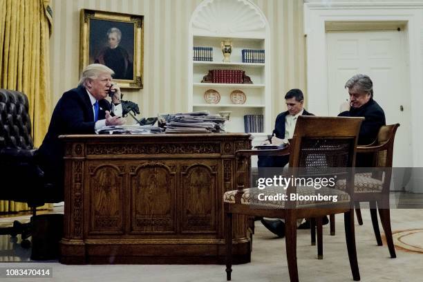 President Donald Trump, left, speaks on the phone with Malcolm Turnbull, Australia's prime minister, as retired Lieutenant General Michael Flynn,...