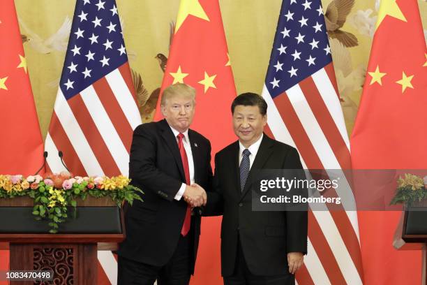 President Donald Trump, left, and Xi Jinping, China's president, shake hands during a news conference at the Great Hall of the People in Beijing,...