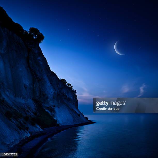 night shot of mountains and sea - crescent stock pictures, royalty-free photos & images