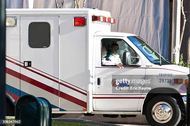 An ambulance, with husband Mark Kelly in the passenger seat, transfers U.S. Rep. Gabrielle Giffords from the ICU at Memorial Hermann Hospital to the...