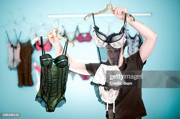 young man shopping for lingerie - men wearing bras photos stock pictures, royalty-free photos & images