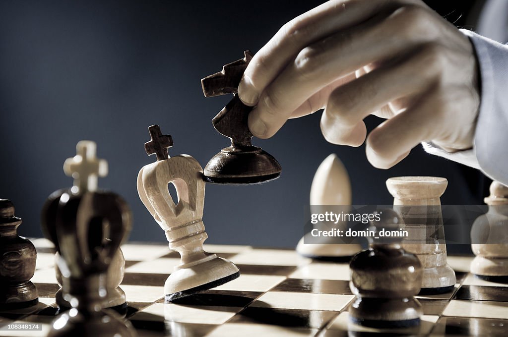 Checkmate Strategy, close-up of chess player, businessman making checkmate move