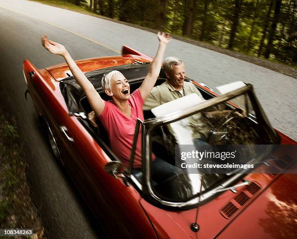 senior couple going for a drive - convertible stockfoto's en -beelden