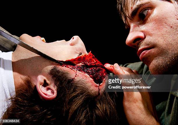 psycho killer cutting victims face off - head wound stock pictures, royalty-free photos & images