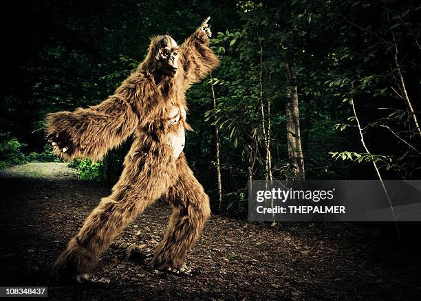 bigfoot making a disco dancing step on the road - bigfoot stock pictures, royalty-free photos & images