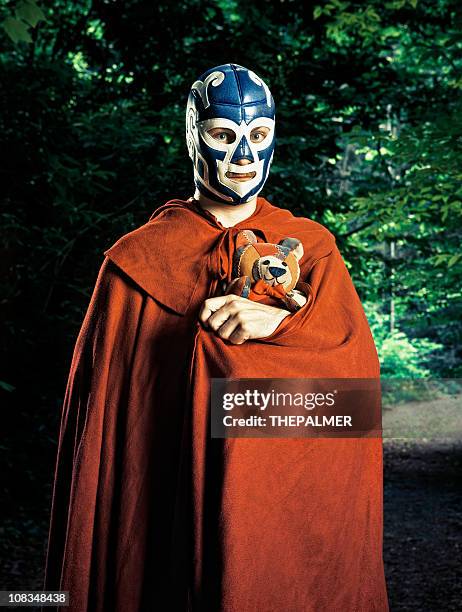 mexican lucha libre fighter with stuffed toy - sportmasker stockfoto's en -beelden